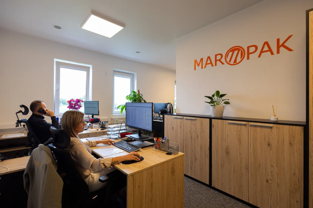 Biuro Maropak z pracownikami przy komputerach i logo firmy na ścianie
